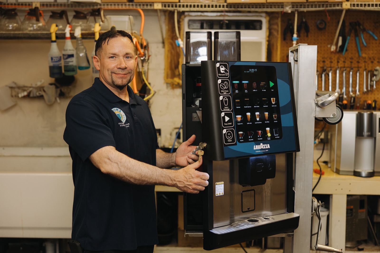Aroma technician with a Lavazza bean-to-cup machine in the service shop