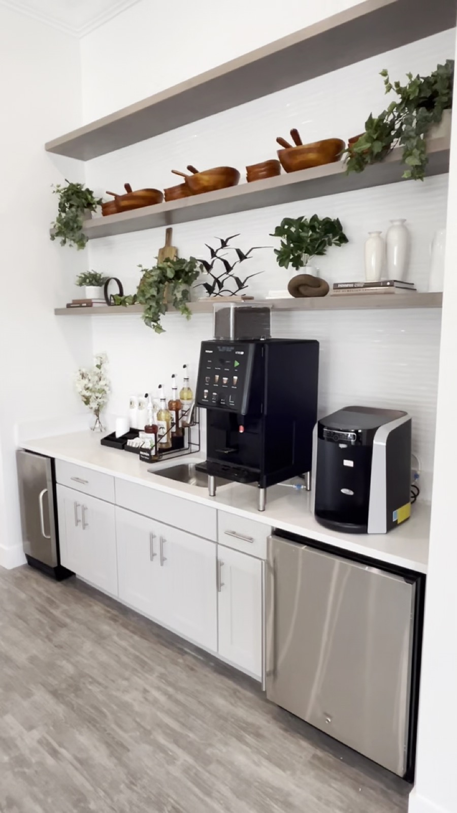 Bright breakroom with a bean-to-cup coffee machine and a countertop water dispenser